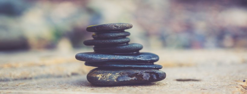 Stock photo of a small pile of flat black pebbles.